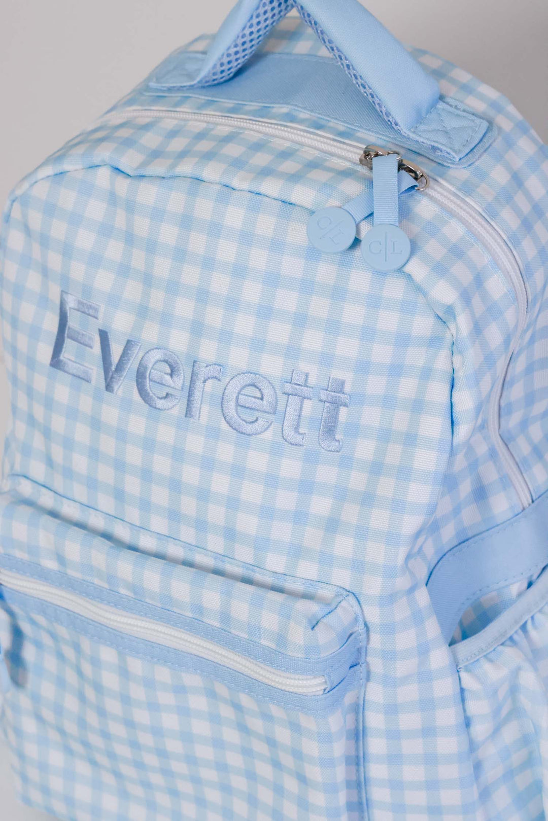 top view of blue embroidered blue gingham backpack 