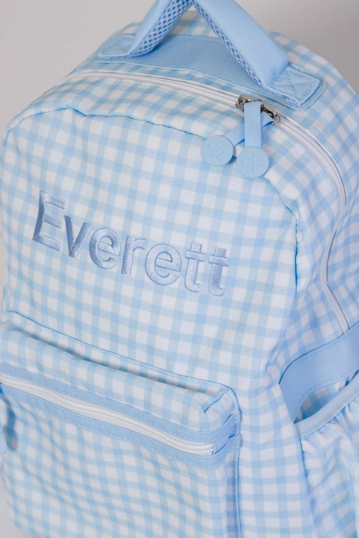 top view of blue embroidered blue gingham backpack 