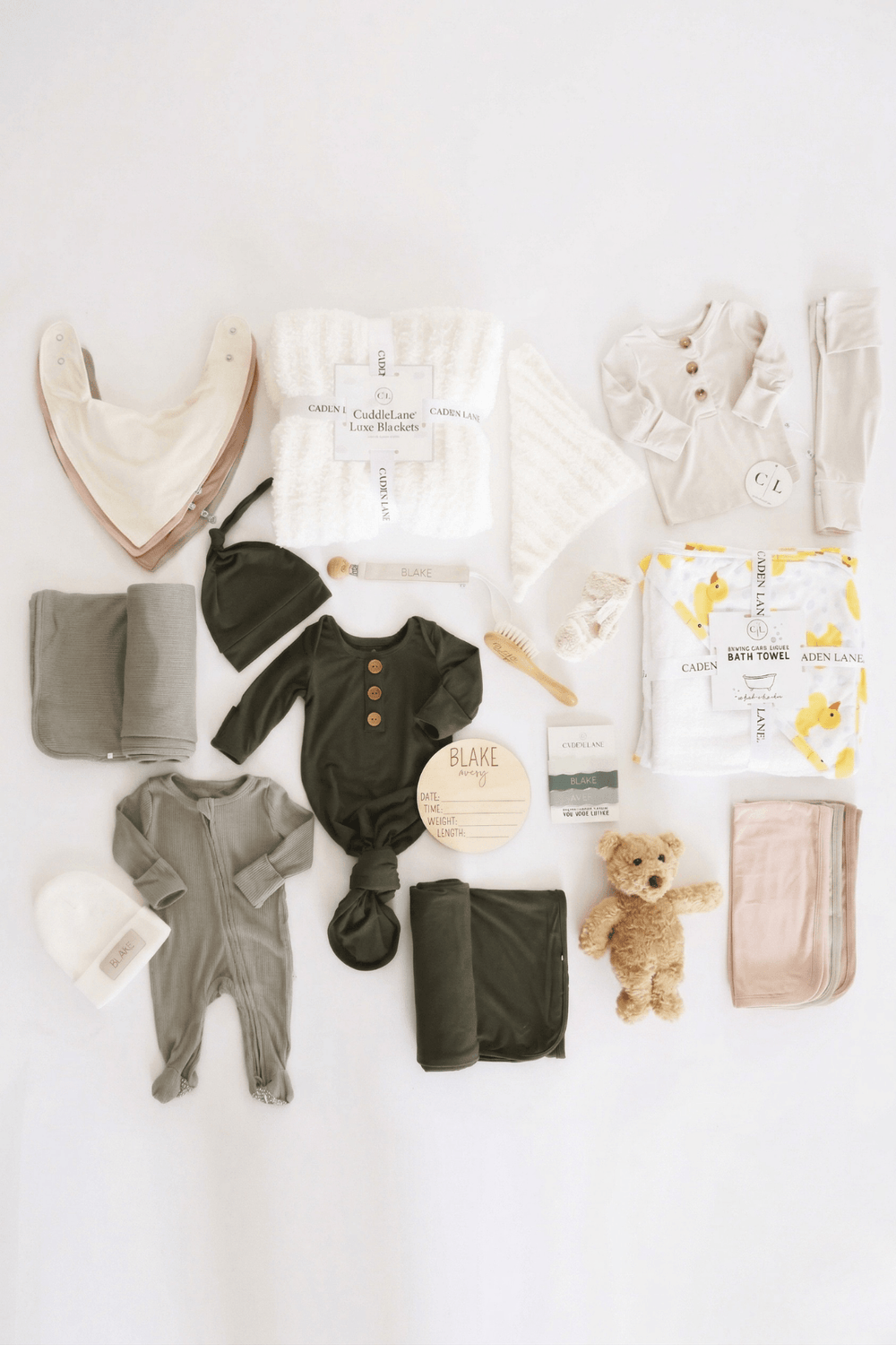 deluxe baby shower gift box bundle with neutral 2pc waffle, zipper footie, knot gown, wood  stats, swaddles, bottle labels, burps, socks, paci clip, beanie, lovey, blanket, hooded towel, hair brush, bear stuffed animal