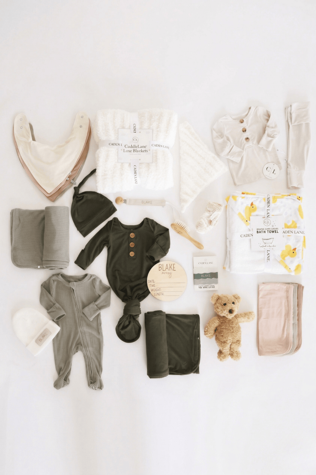 deluxe baby shower gift box bundle with neutral 2pc waffle, zipper footie, knot gown, wood  stats, swaddles, bottle labels, burps, socks, paci clip, beanie, lovey, blanket, hooded towel, hair brush, bear stuffed animal