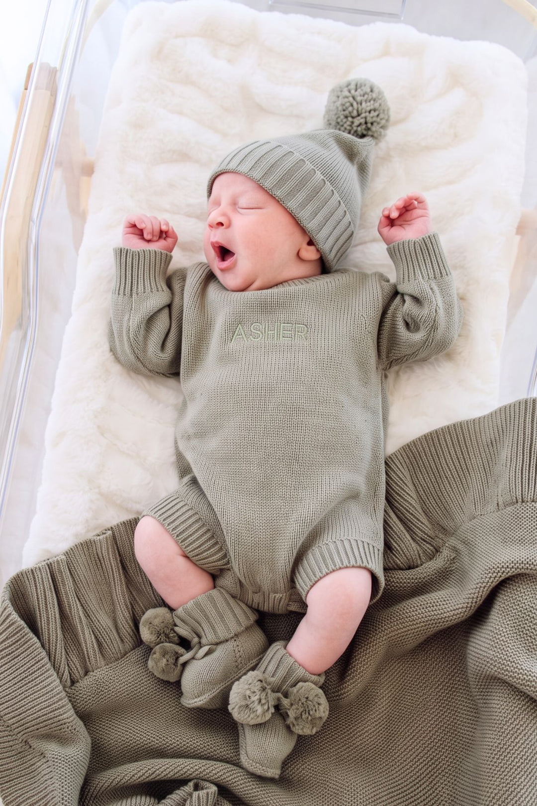 Newborn wearing Caden Lane personalized Caden Lane smoke knit bubble romper and hat embroidered with the name Asher