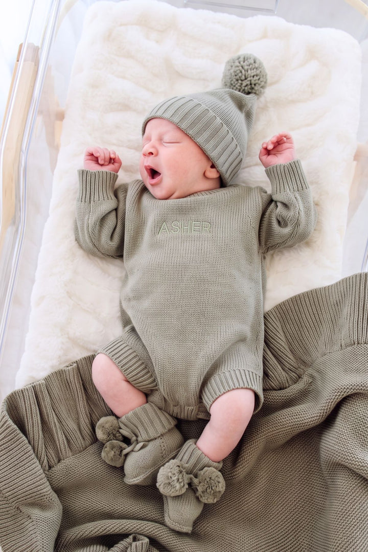 Newborn wearing Caden Lane personalized Caden Lane smoke knit bubble romper and hat embroidered with the name Asher