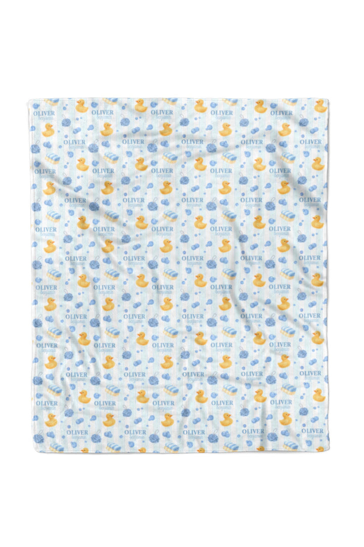Boy holding 50x60 blue Bubble Duckies personalized blanket with yellow rubber duck and blue bubble print custom name