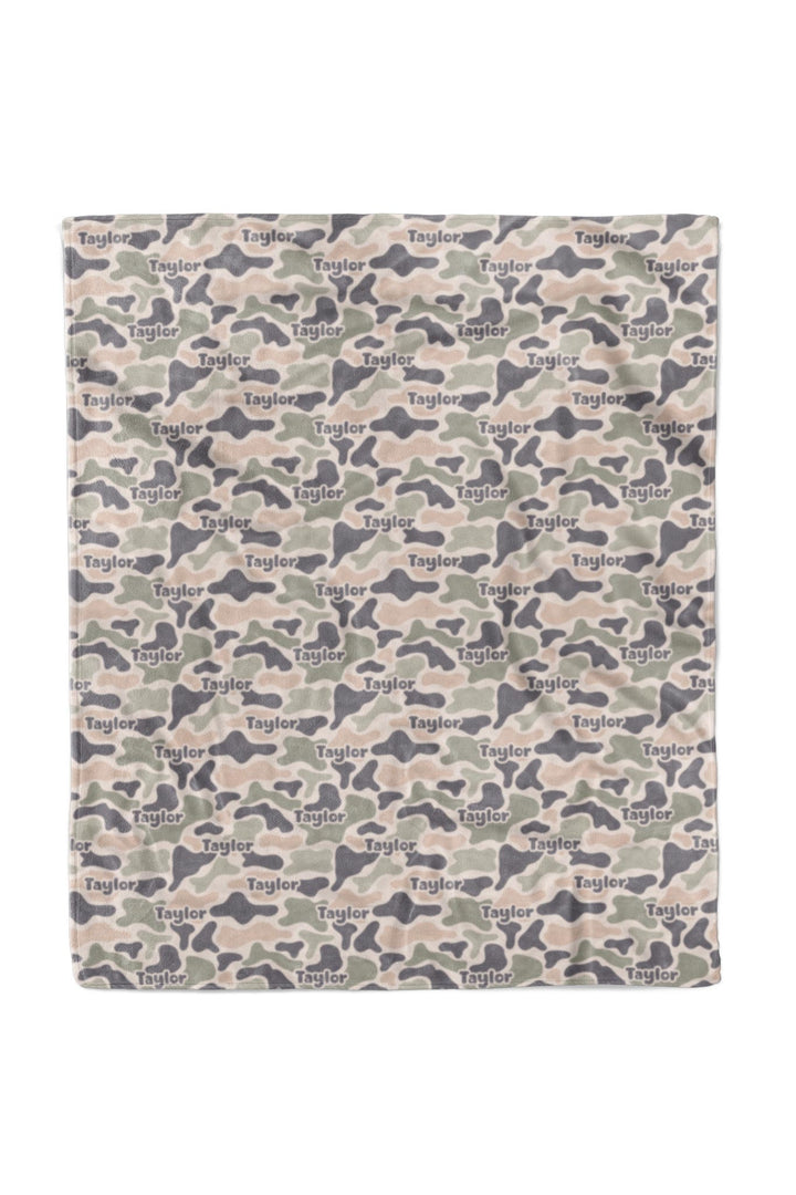 Full flat lay of 50x60 personalized camo cutie kids blanket showing camo print with custom name repeated across the entire surface