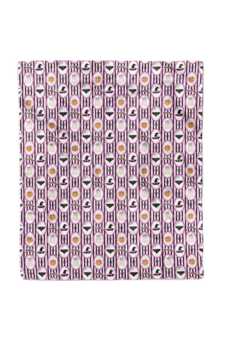 Pink and black Halloween blanket fabric with ghost, bat, pumpkin, and heart pattern.