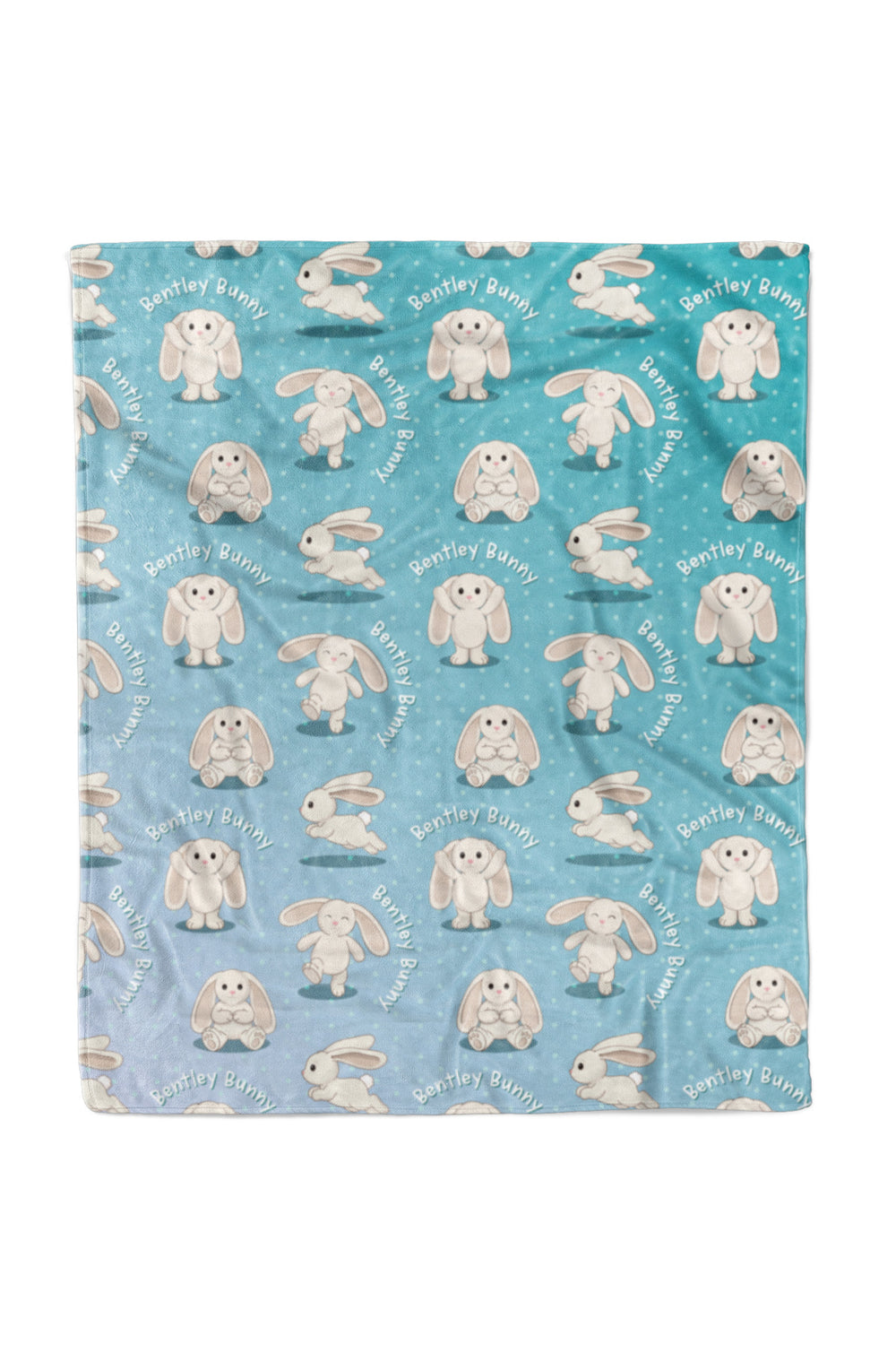 Flat lay of a Caden Lane personalized "Bentley Bunny" fleece baby blanket in a teal-to-blue ombre polka dot pattern, covered in a repeating print of a bunny character in different poses with "Bentley Bunny" text arched throughout.