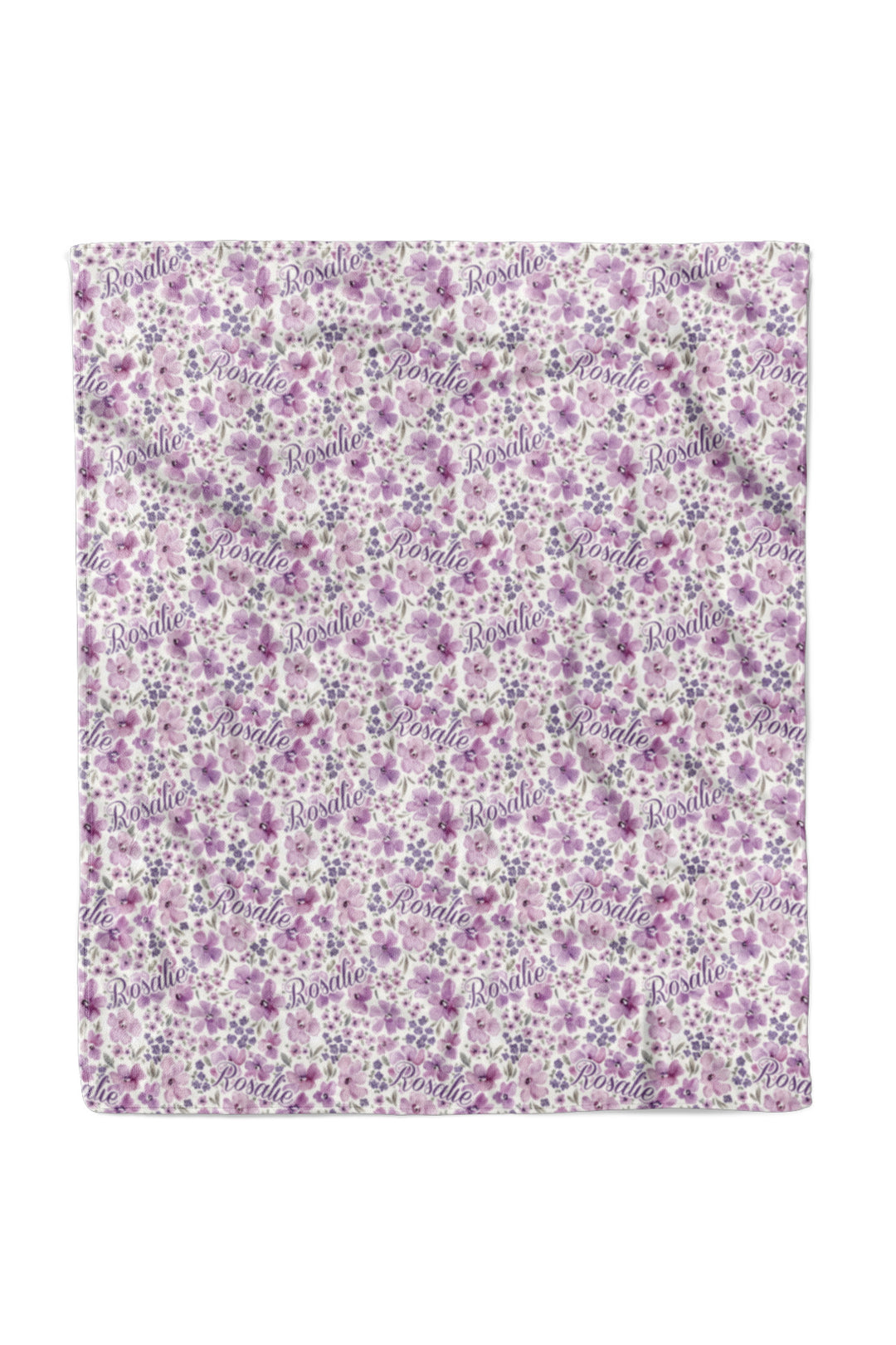 Flat lay of a fully spread Caden Lane white plush 50x60 blanket in a Lilac Dreams print featuring purple and pink watercolor flowers, reading "Rosalie."