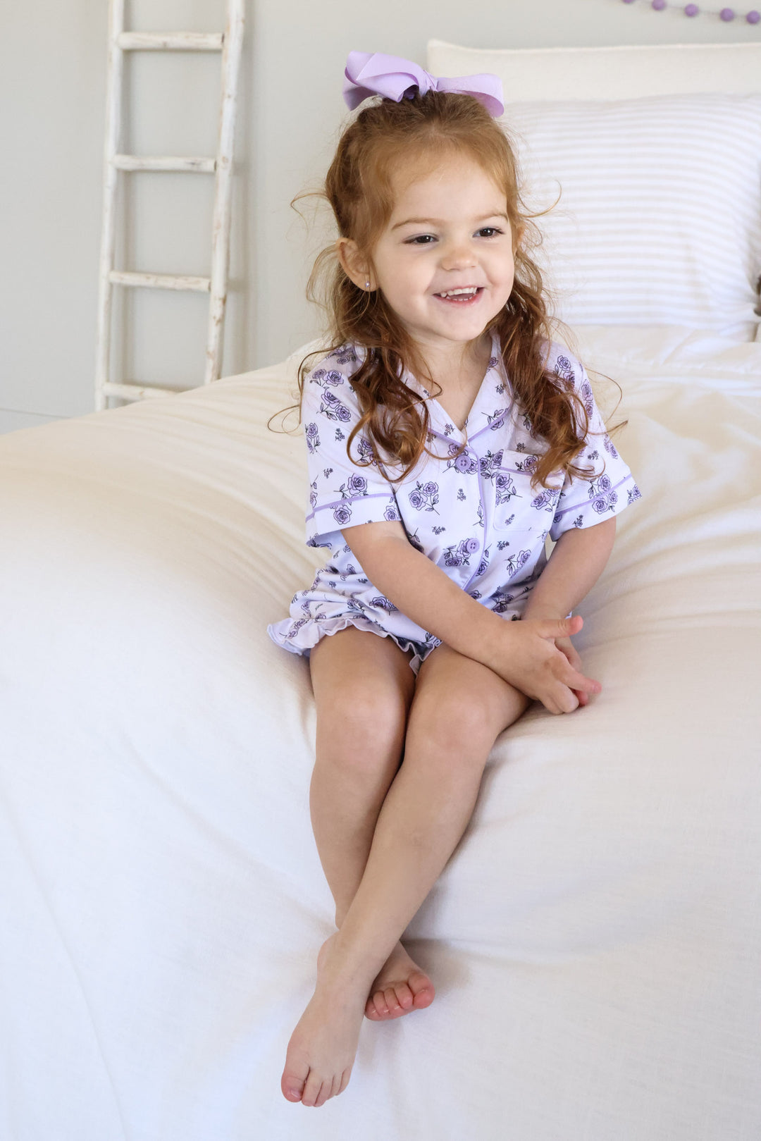 girl sitting on bed in amethyst garden lounge set 