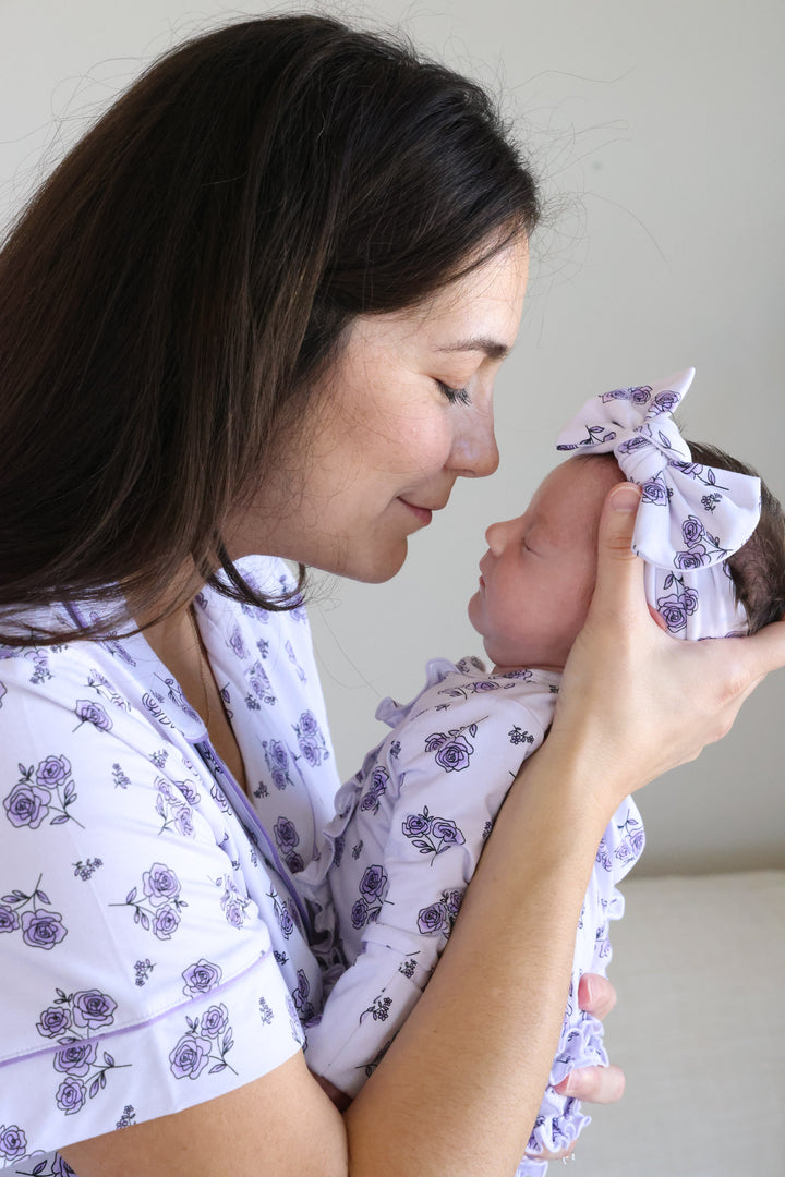 mom leaning in to kiss baby in amethyst garden pajamas 