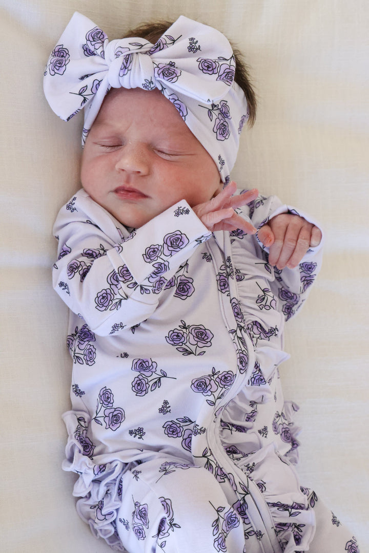baby girl in amethyst garden ruffle footie with matching headwrap
