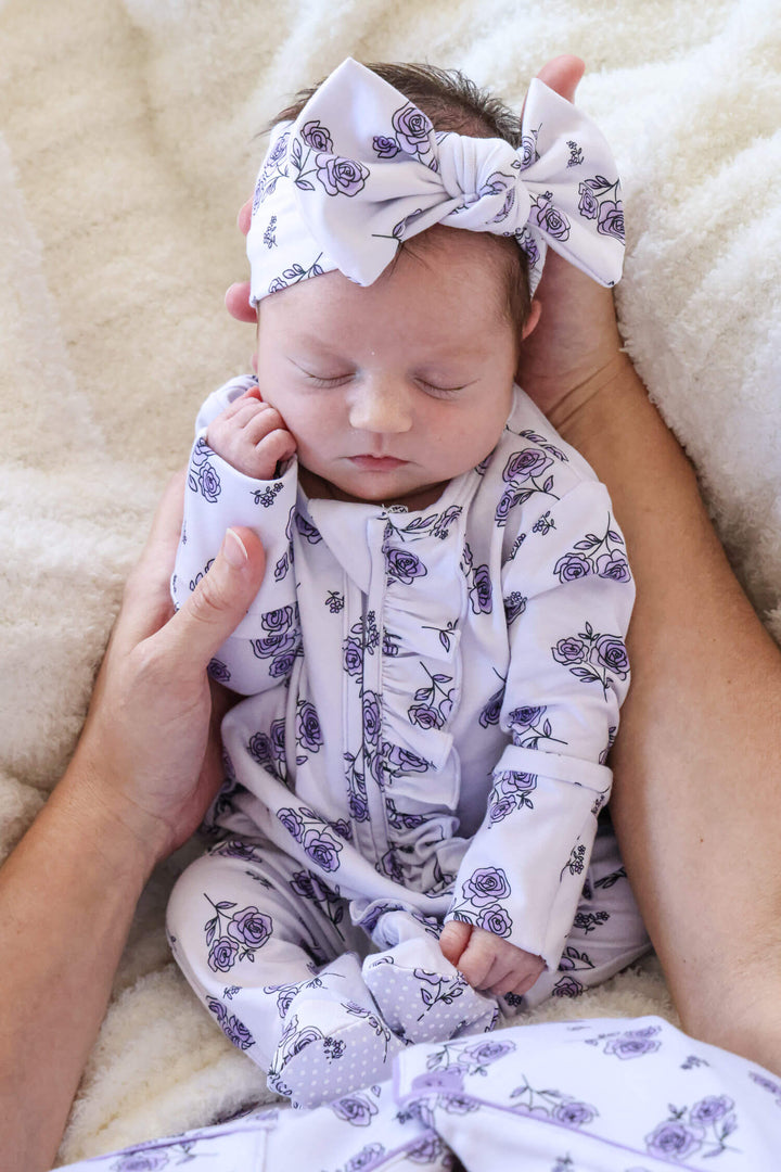 mom holding baby in amethyst garden ruffle zipper footie 