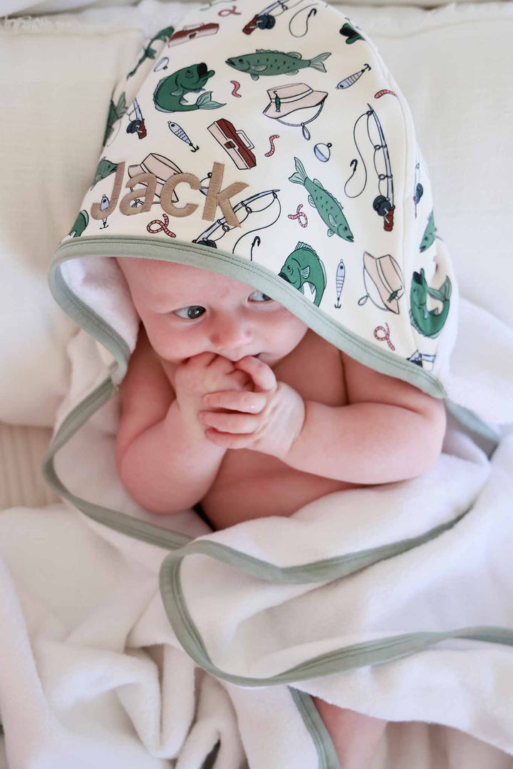 Close-up of baby's head wearing the Off The Hook bamboo hooded towel showing embroidered custom name on hood