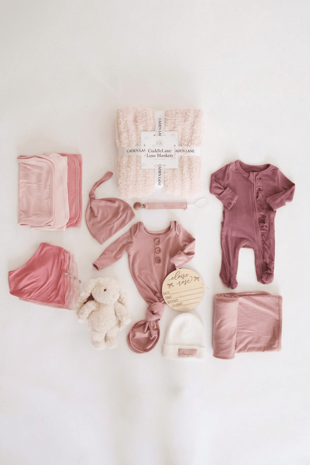 baby shower gift bundle for girls with pink 2pc waffle, zipper footie, knot gown, wood  stats, swaddles, bottle labels, burps, socks, paci clip, beanie, lovey, blanket, hooded towel, hair brush, bunny stuffed animal
