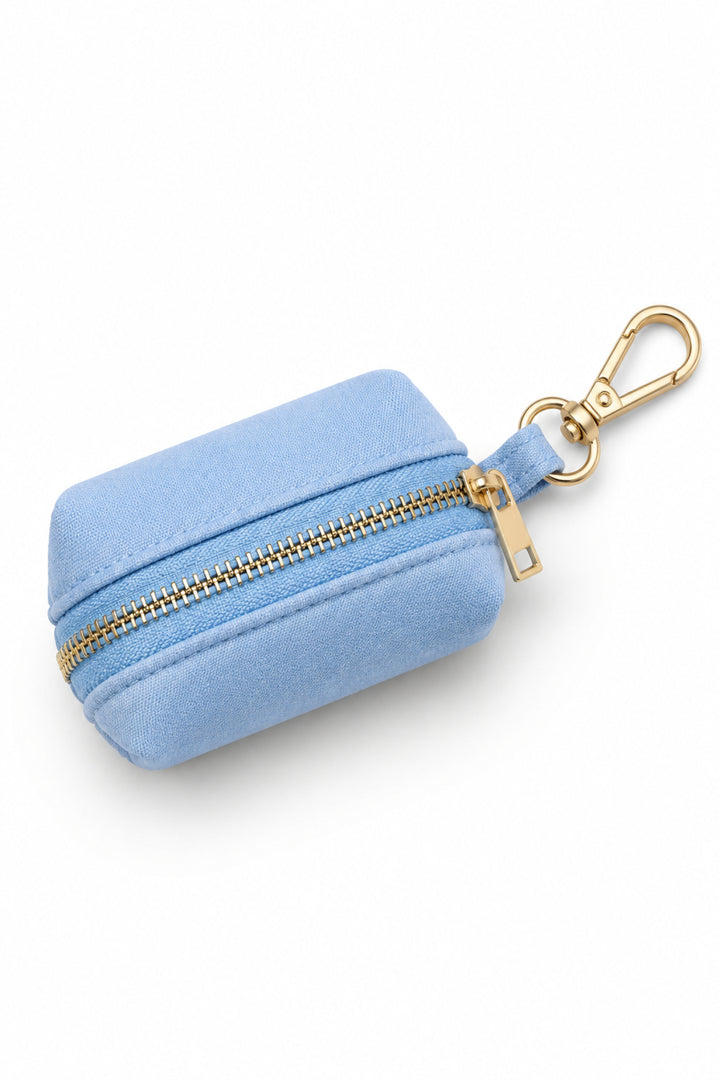 Caden Lane denim days light blue waste bag holder with gold zipper and carabiner clip, shown from above on white background