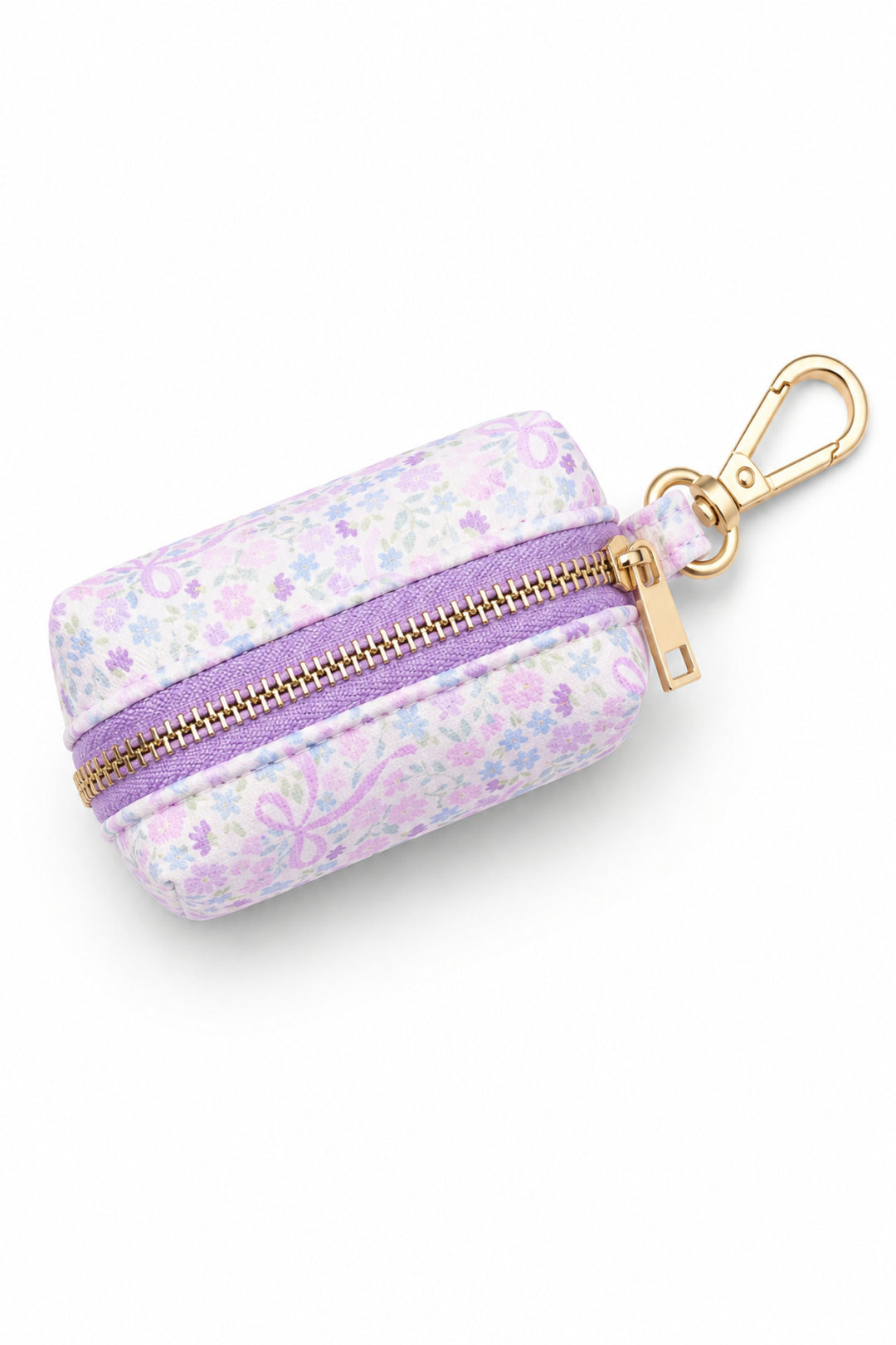 Pet waste bag holder in the Ribbon Garden print — pink and lavender floral fabric — with a purple zipper and gold carabiner clip, shown from the top on a white background