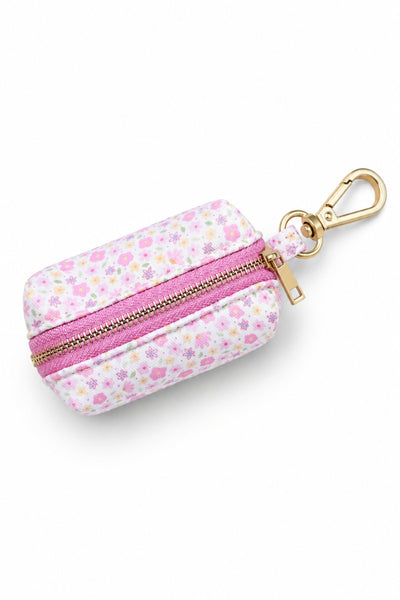 Scattered Blooms pet waste bag holder with pink ditsy floral print, pink zipper, and gold carabiner clip for attaching to leash or harness