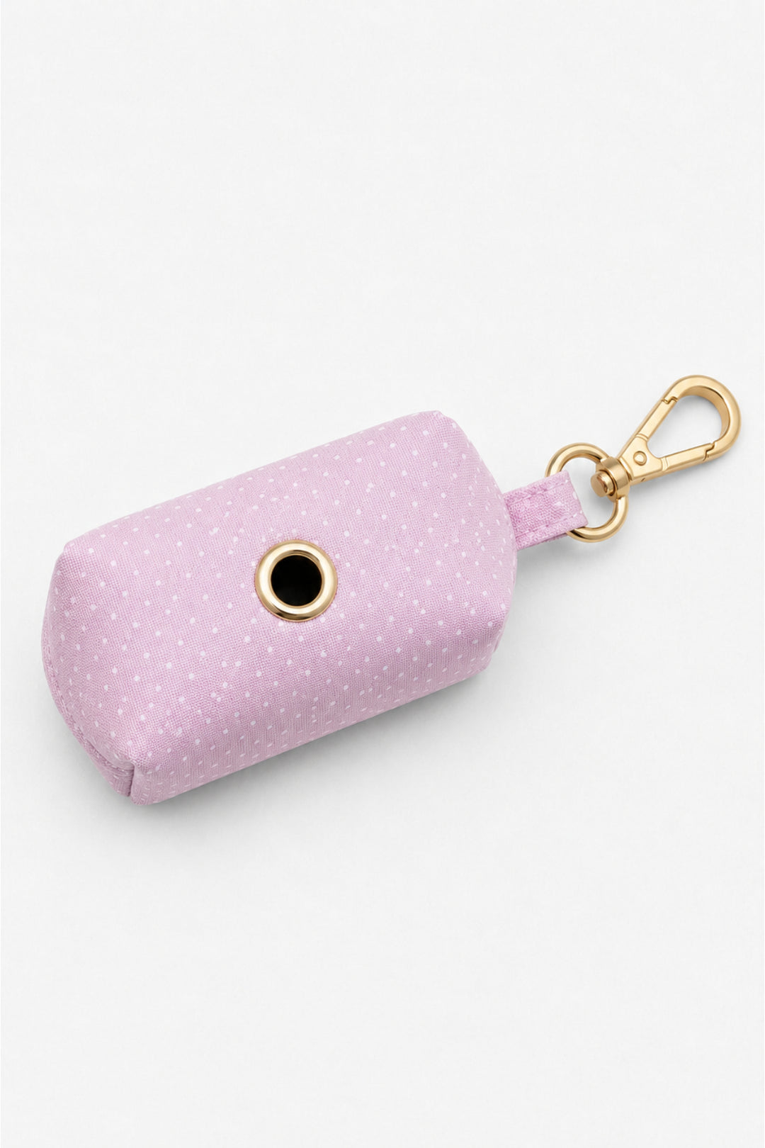 Bottom view of pink polka dot pet waste bag holder showing the circular dispensing opening with gold metal grommet and gold carabiner clip