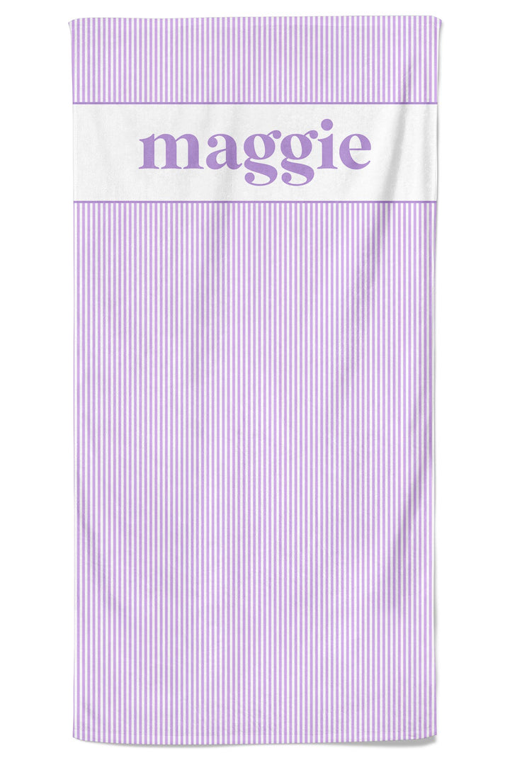 Personalized pet towel in lavender and white vertical stripes with a white top section and the name maggie in purple script