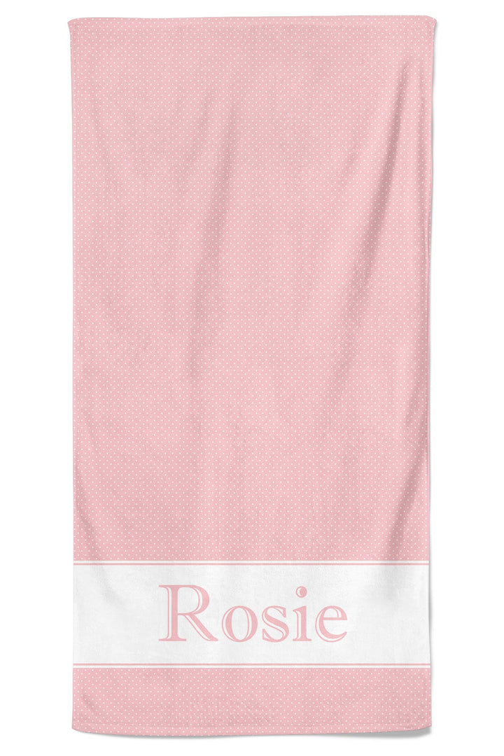 Pink polka dot pet towel laid flat with a white bottom band personalized with the name Rosie in large pink lettering