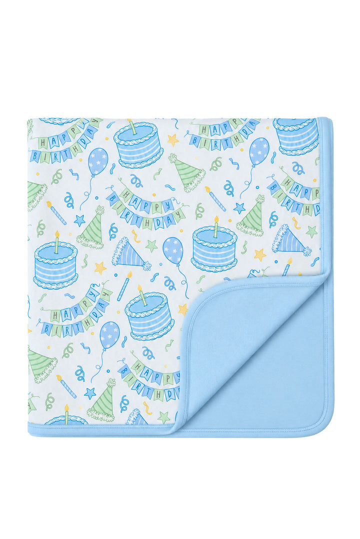 Caden Lane double-sided bamboo blanket in Birthday Bash Blue, featuring birthday cakes, balloons and party hats.