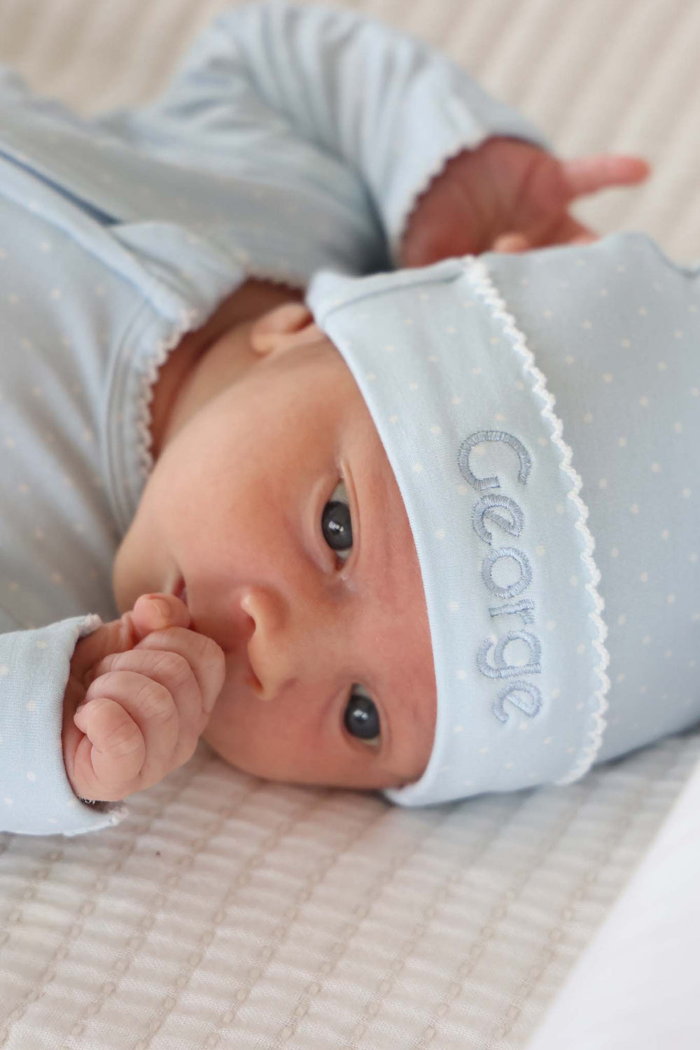 newborn in blue picot trim bamboo hat