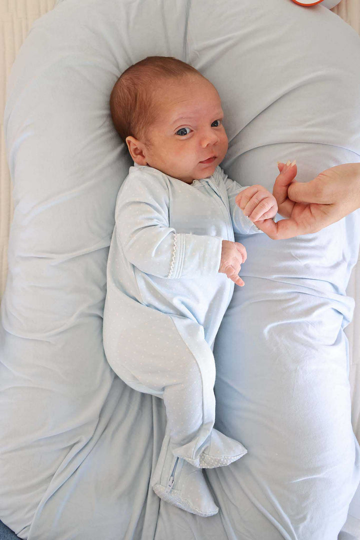 baby in blue picot trim bamboo zipper footie outfit