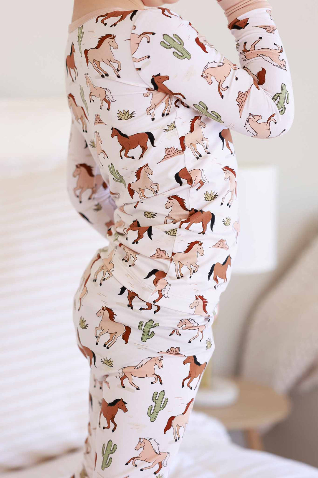 closeup of neutral pony club print two piece pajama set 