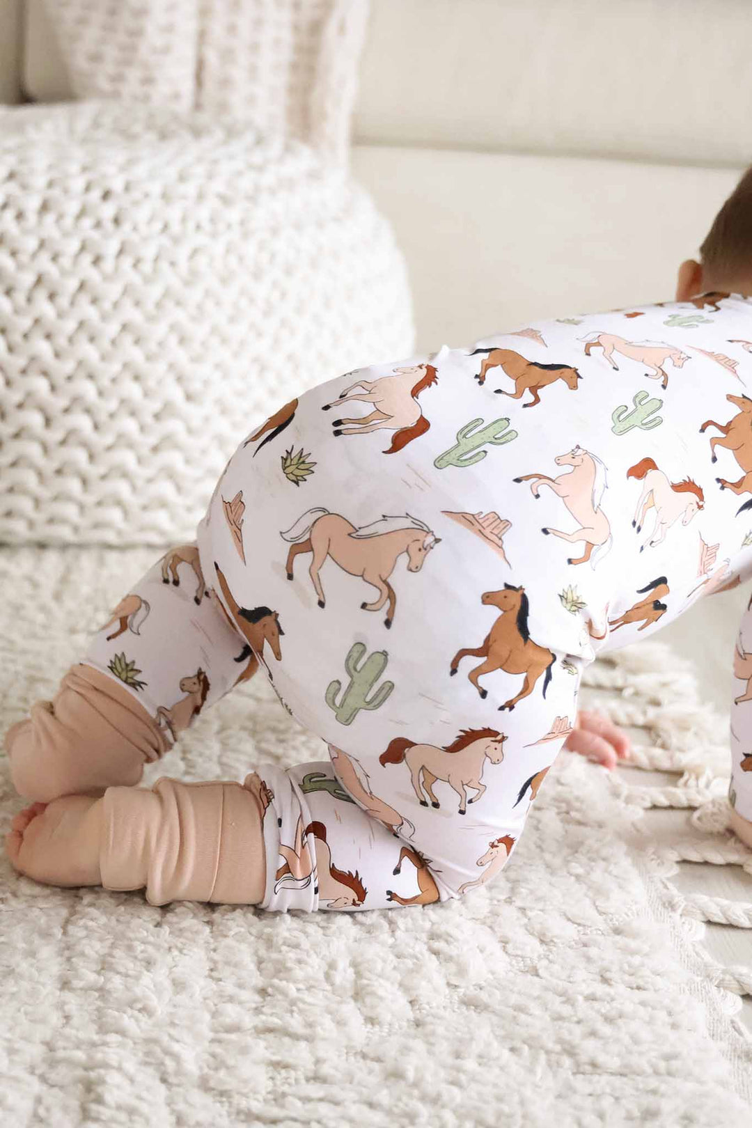 closeup of neutral pony club convertible zip romper 