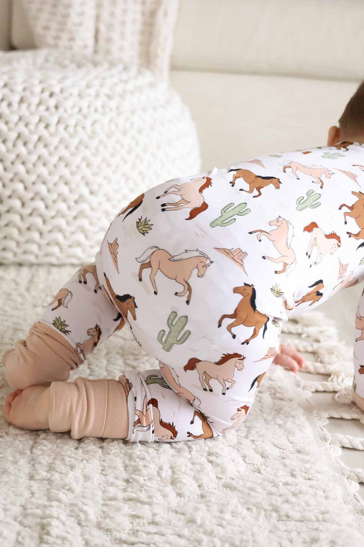 closeup of neutral pony club convertible zip romper 