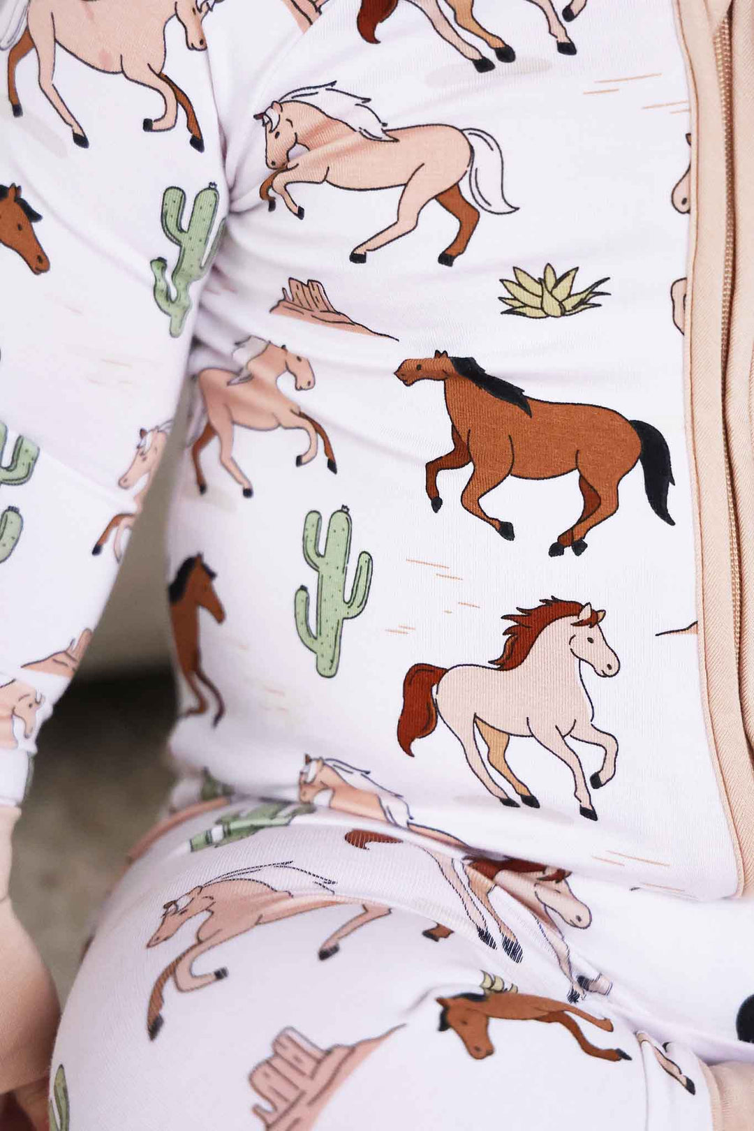 closeup of horse and cactus convertible zip romper pajama for boys 