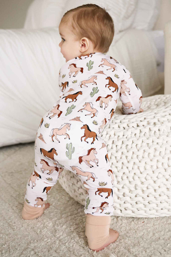 back view of neutral pony club zip romper