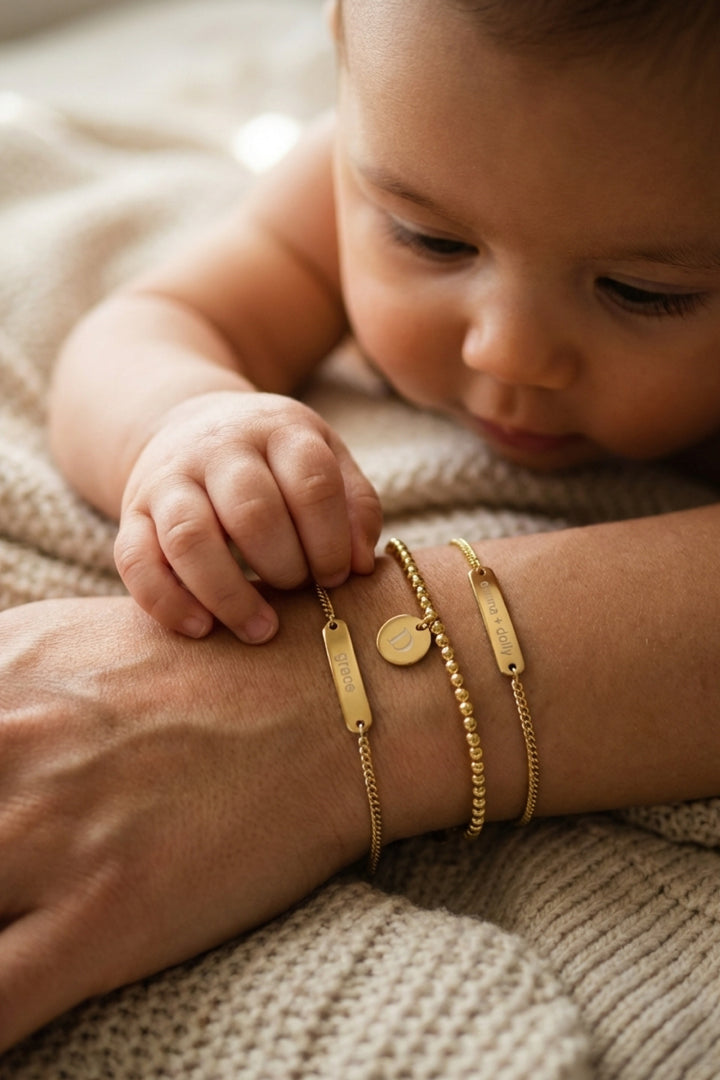 baby playing with mom's bracelets