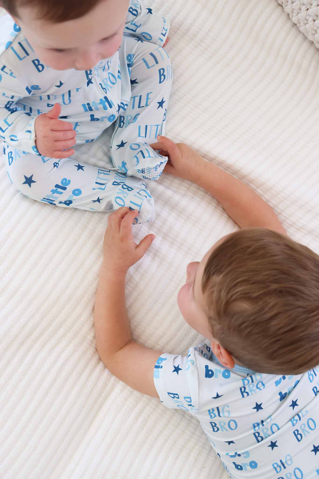 brothers playing wearing matching big bro and little bro pajamas 