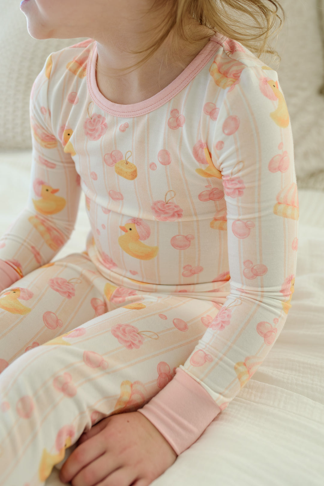 Close-up of pink Bubble Duckies two-piece bamboo pajama top showing yellow rubber duck and pink rose print detail
