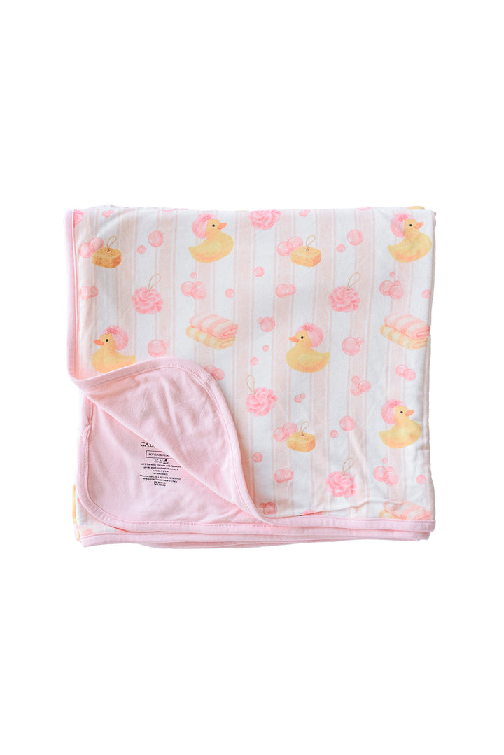 Folded pink Bubble Duckies double-sided bamboo blanket with yellow rubber duck and pink rose print on white background