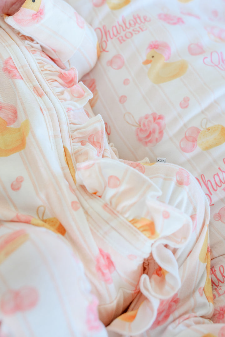 Macro close-up of pink Bubble Duckies ruffle footie ruffle detail on personalized rubber duckie blanket