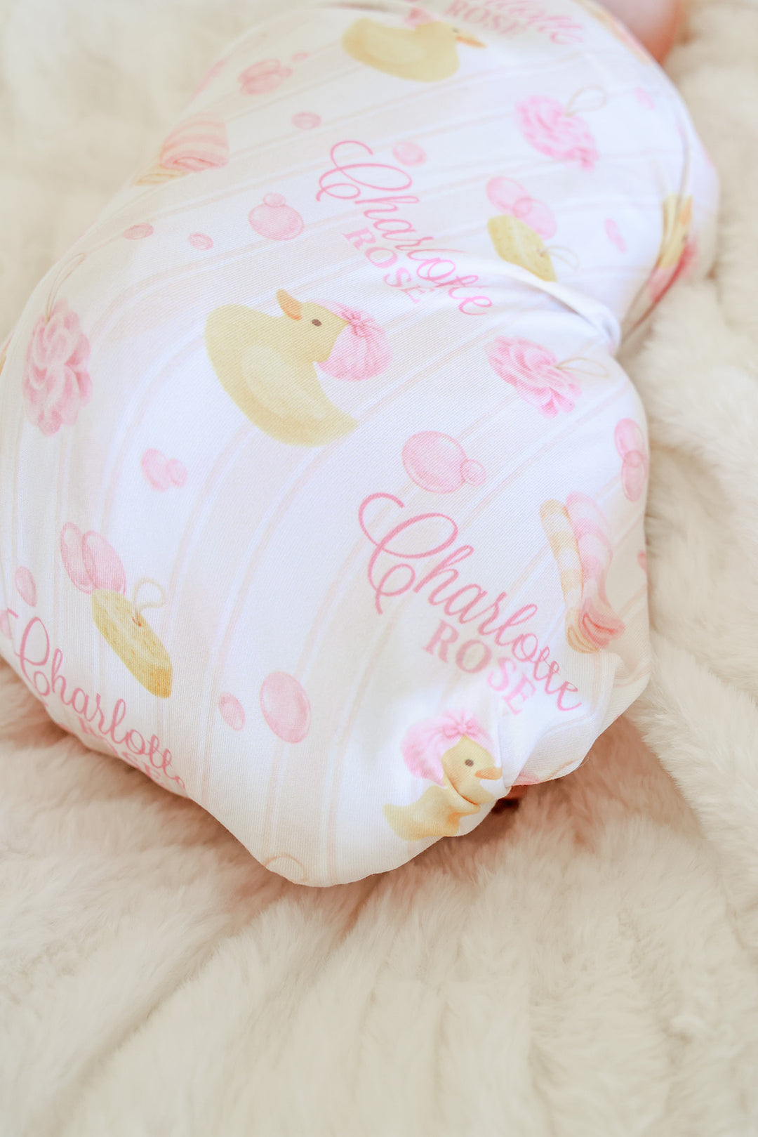 closeup of pink rubber duck bath time themed personalized swaddle blanket