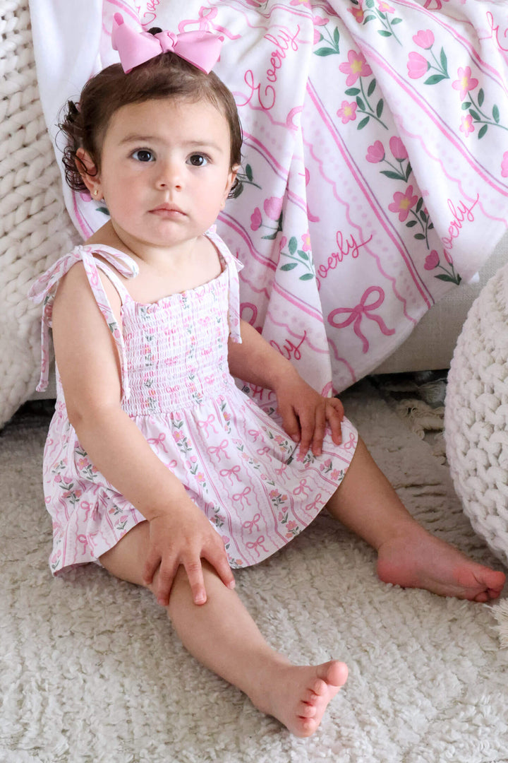 caden lane smocked twirl bodysuit in coquette garden floral print for newborns