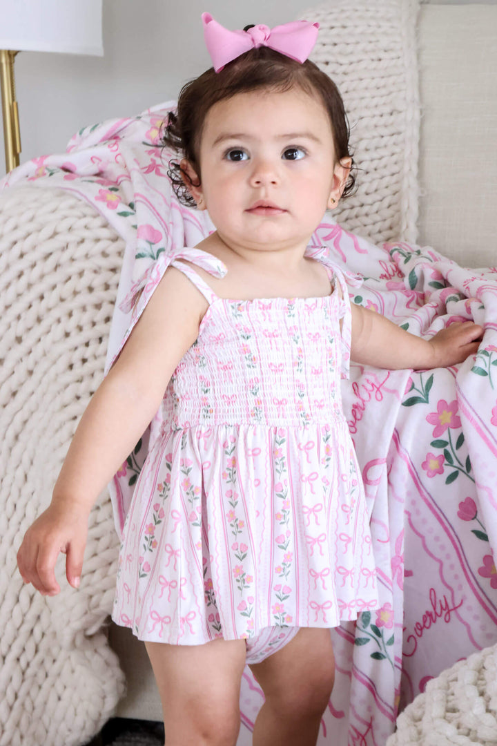 caden lane smocked twirl bodysuit coquette garden print - bows and flowers for babies