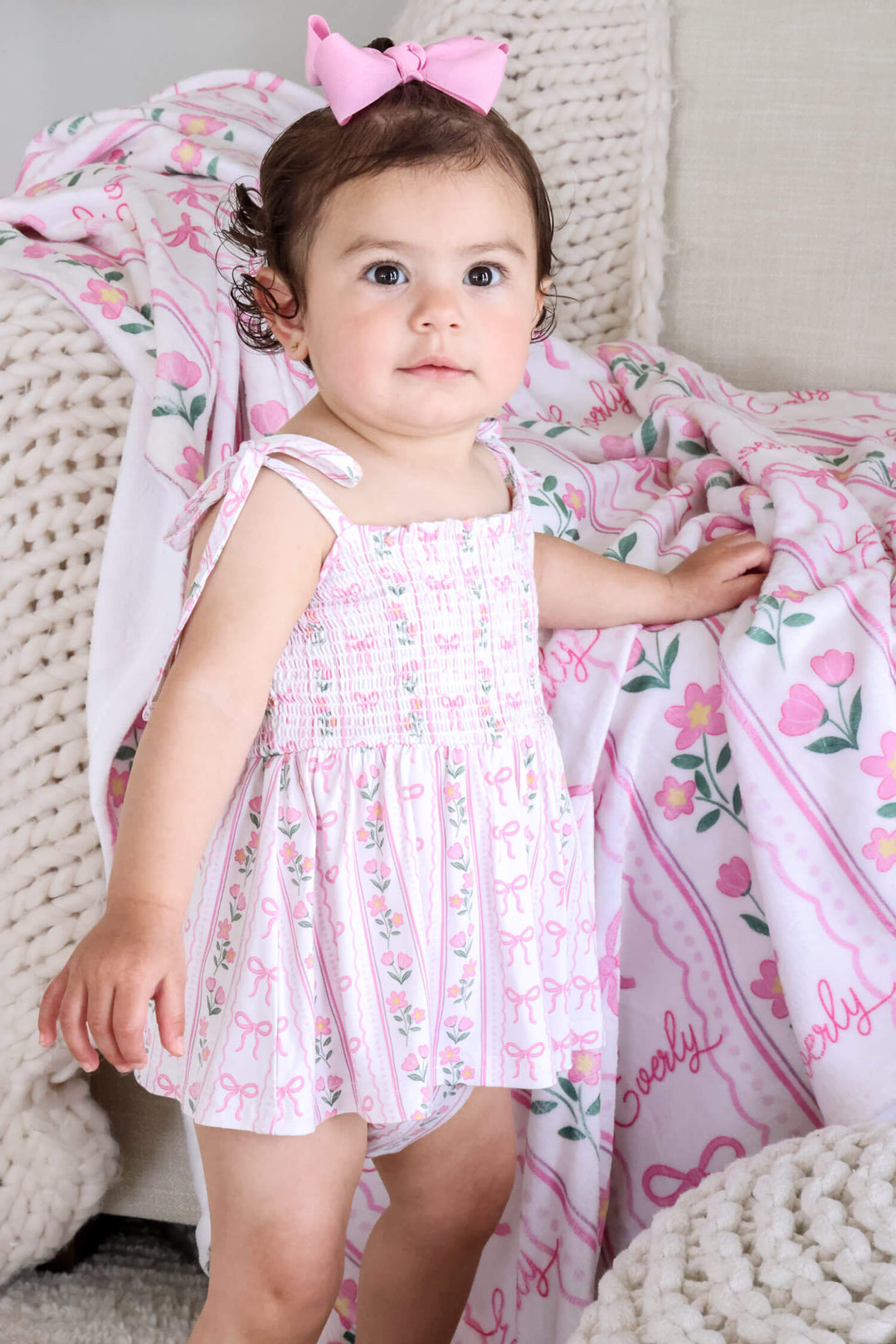 baby smocked twirl bodysuit featuring coquette garden bows and flowers