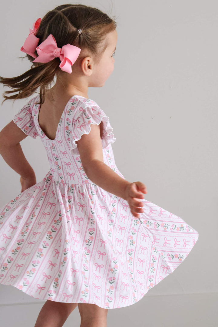 coquette garden ruffle twirl dress with bows and blooms