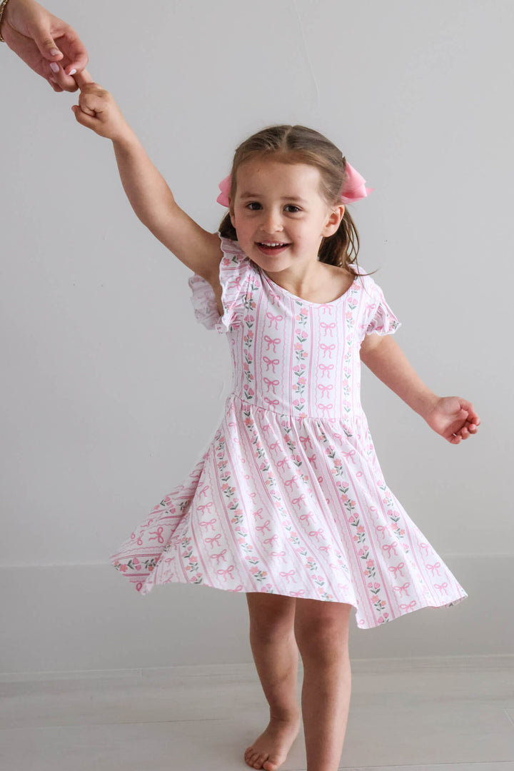 ruffle twirl dress with coquette garden bow and flower details