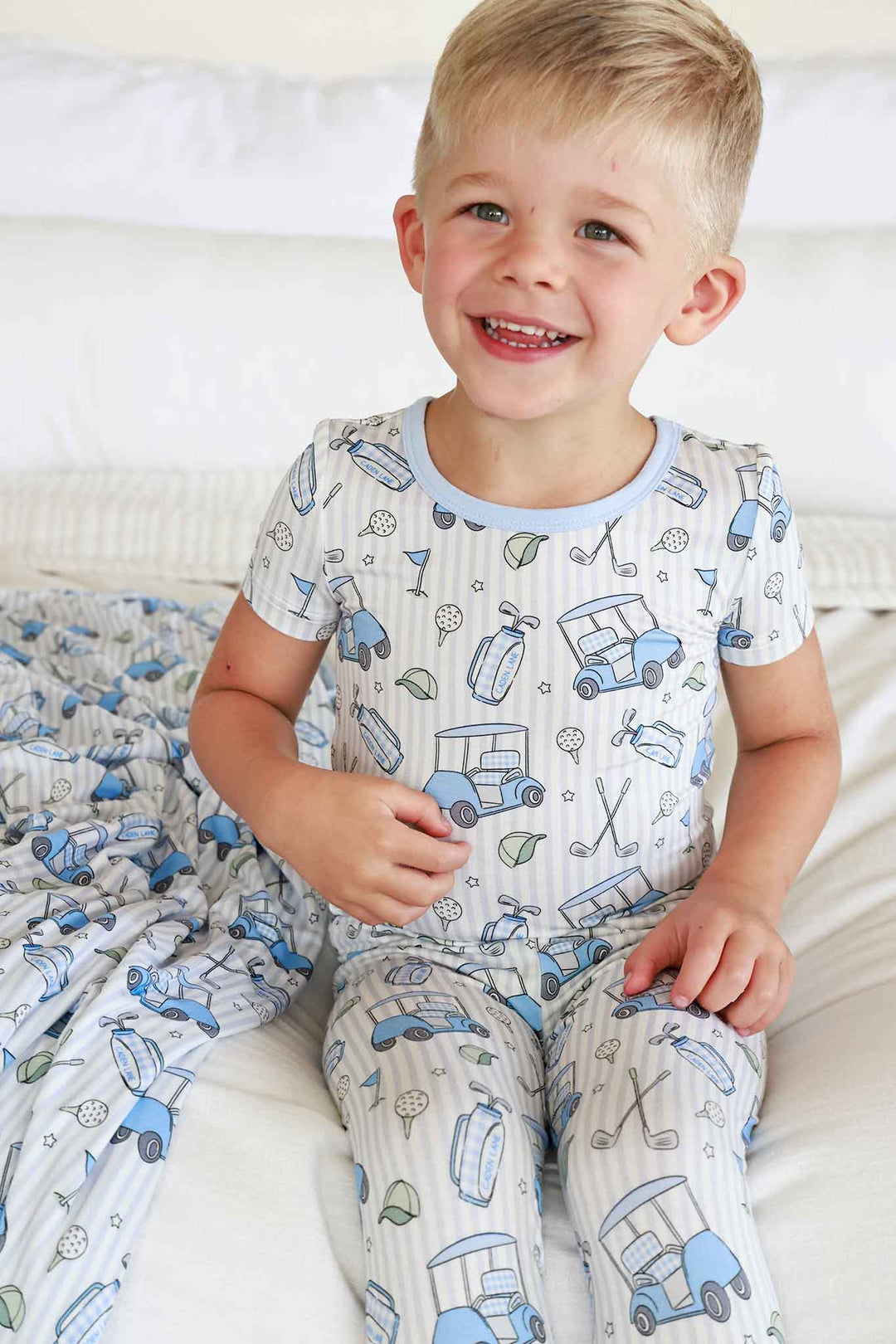 smiling boy in caddie crew pajamas