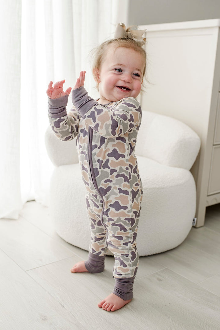 Camo cutie convertible zip romper on baby toddler sitting from behind