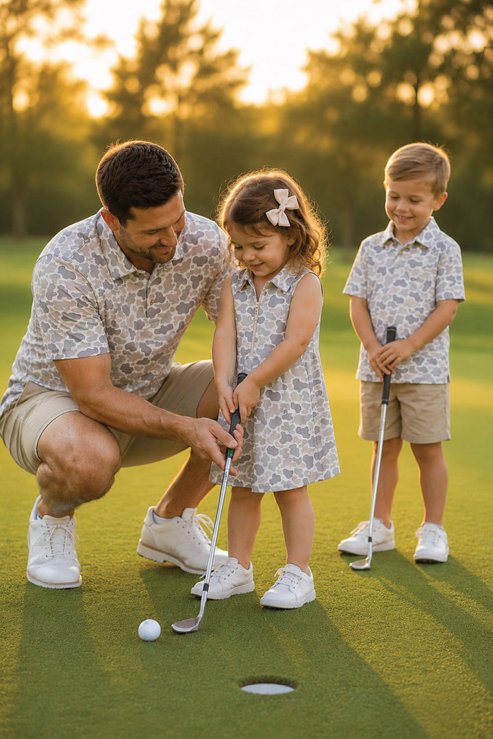 dad with son and daughter playing golf