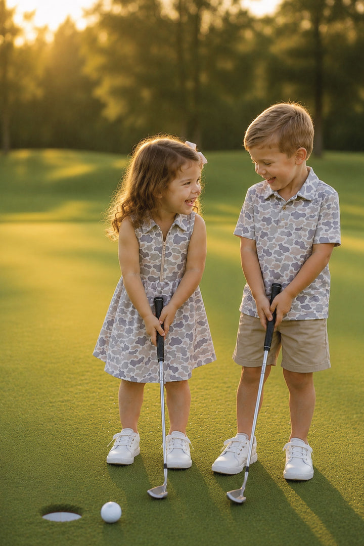 brother and sister in matching camo golf dress and polo