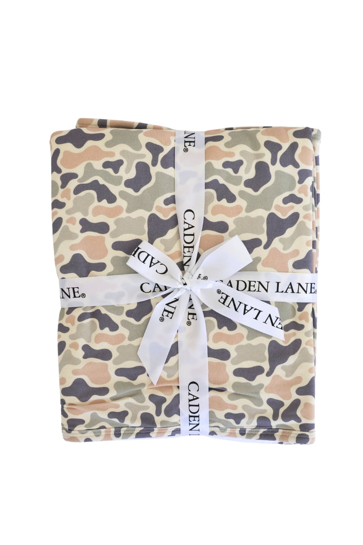 Camo cutie bamboo hooded towel folded and tied with a Caden Lane ribbon bow, ready for gifting