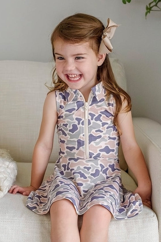 girl sitting on chair in camo cutie athletic dress