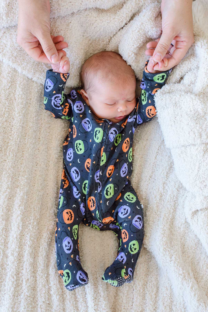 baby laying on soft blanket in candy crawl bamboo waffle zipper footie 