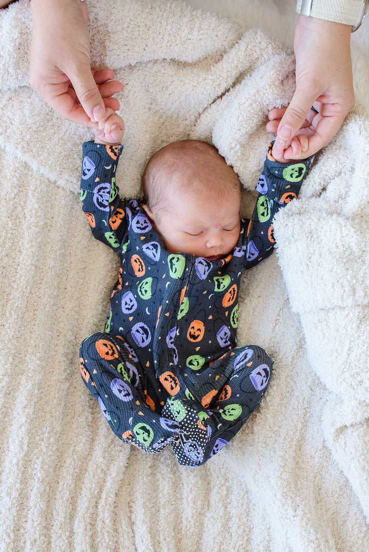 baby in halloween zipper footie in candy crawl print 